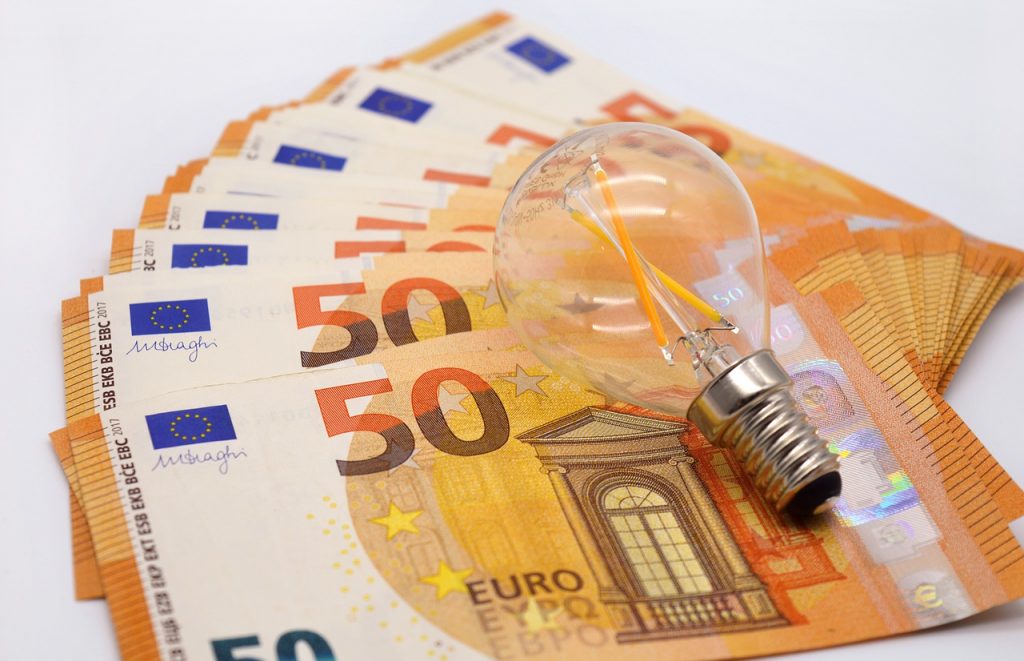 money-finance-cash-7727565 a light bulb on a stack of money